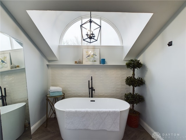 bathroom with a bath and parquet flooring