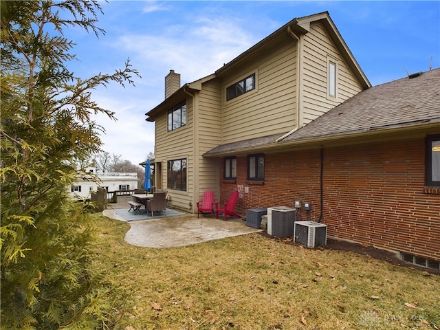 back of property featuring a yard, a patio area, and central air condition unit