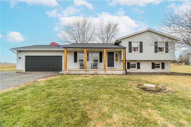 split level home featuring a garage, a front lawn, and a porch