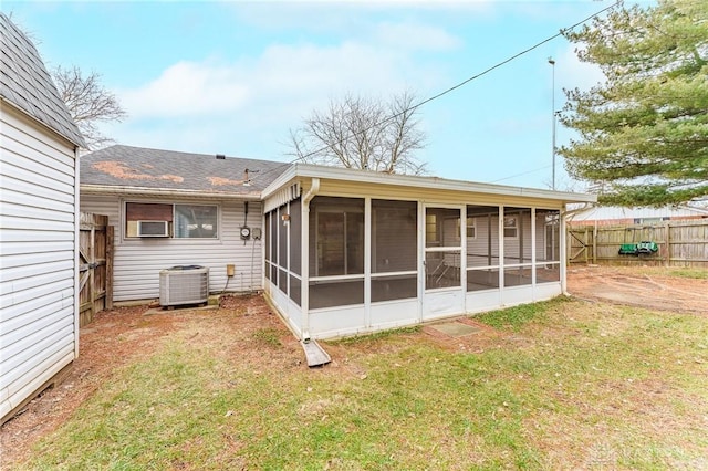 back of property featuring a yard, a sunroom, and central air condition unit