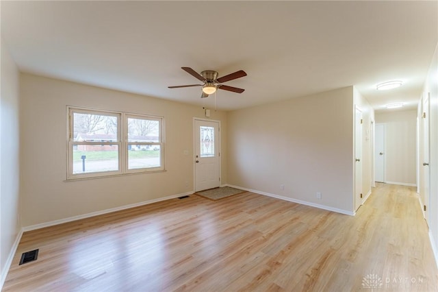 empty room with ceiling fan and light hardwood / wood-style floors