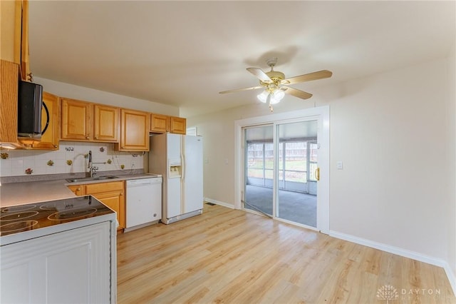 kitchen with sink, decorative backsplash, white appliances, ceiling fan, and light wood-type flooring