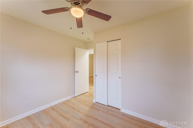 unfurnished bedroom featuring light hardwood / wood-style flooring, a closet, and ceiling fan