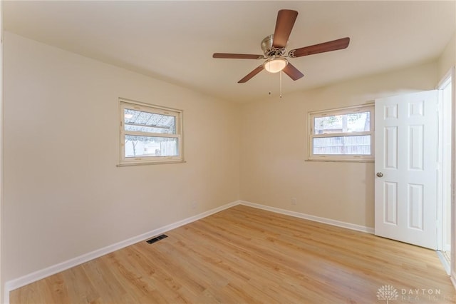 spare room with light hardwood / wood-style floors and ceiling fan