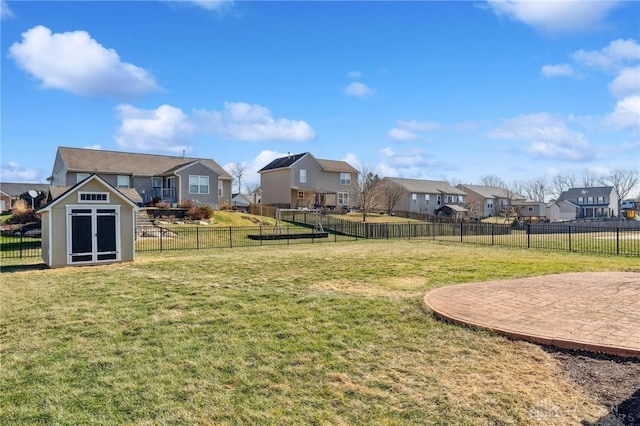 view of yard featuring a storage shed and a patio area