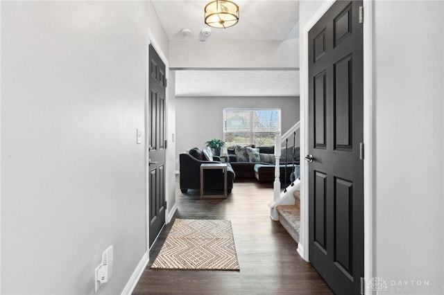 entryway featuring dark hardwood / wood-style floors and a textured ceiling