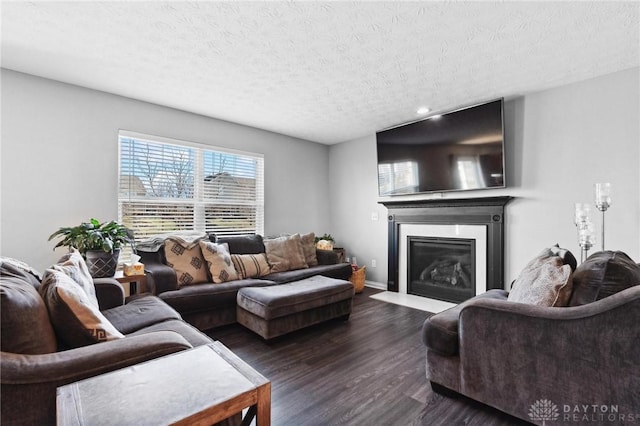 living room with dark hardwood / wood-style floors and a textured ceiling