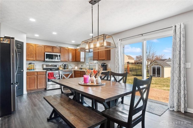 dining area with dark hardwood / wood-style floors, sink, and a textured ceiling