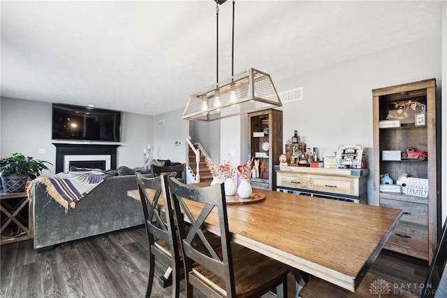 dining area featuring dark wood-type flooring