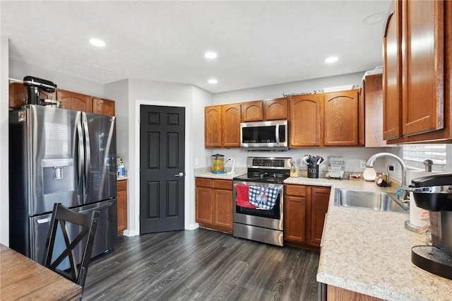 kitchen with sink, stainless steel appliances, and dark hardwood / wood-style floors