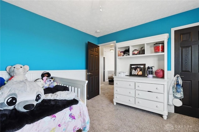 carpeted bedroom featuring a textured ceiling