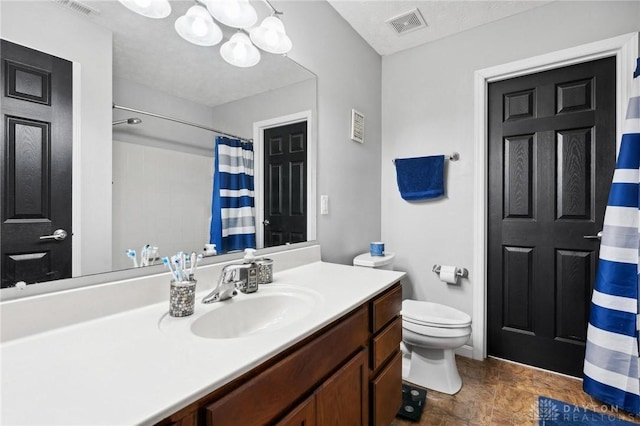 bathroom with vanity, a notable chandelier, and toilet