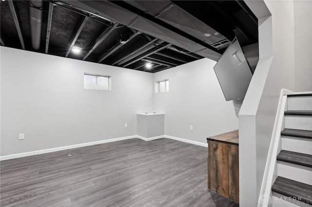 basement featuring dark hardwood / wood-style floors