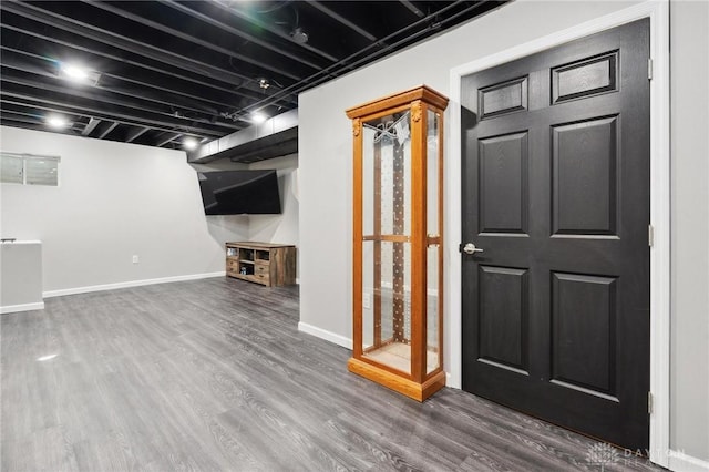 basement with hardwood / wood-style floors