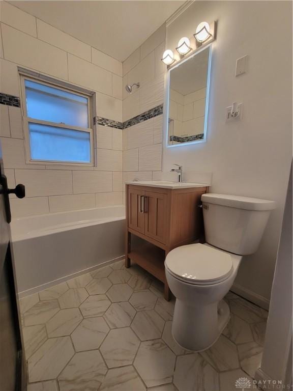 full bathroom featuring tiled shower / bath combo, vanity, and toilet