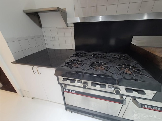 kitchen featuring tasteful backsplash and stainless steel gas range oven