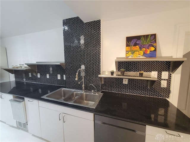 kitchen featuring white cabinetry, dishwashing machine, sink, and tasteful backsplash