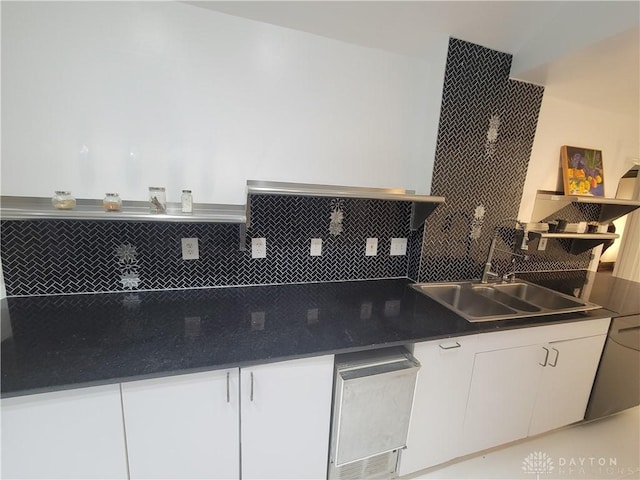 kitchen with sink, decorative backsplash, and white cabinets