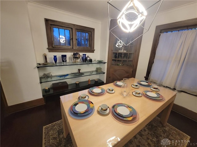 dining space featuring crown molding