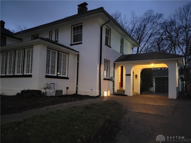 property exterior at dusk featuring a garage