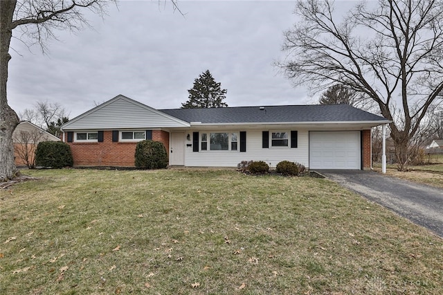 ranch-style home with a garage and a front lawn