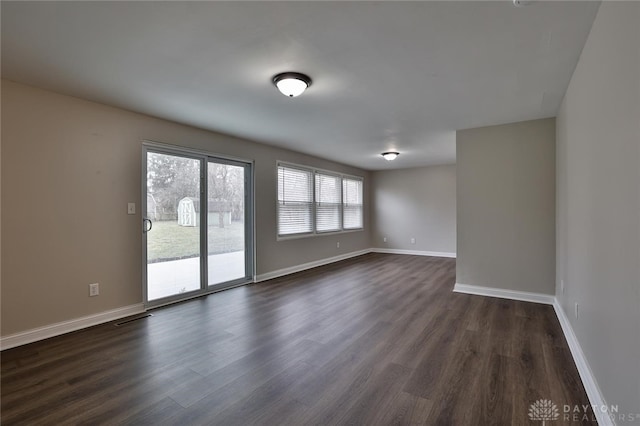 spare room featuring dark hardwood / wood-style floors