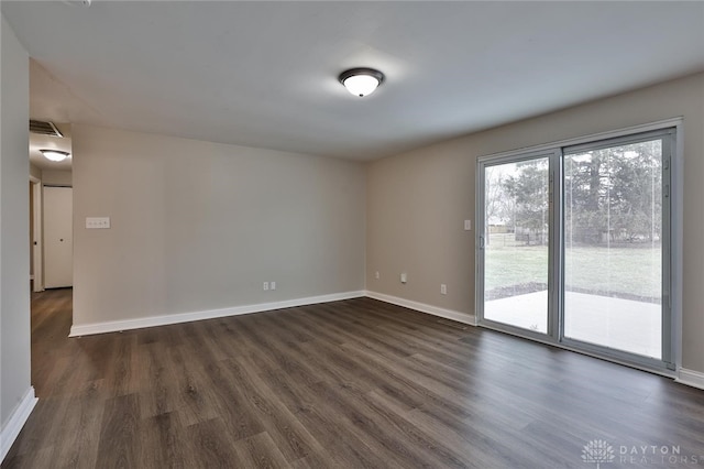 spare room with dark hardwood / wood-style flooring