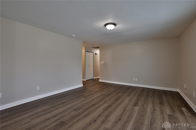 spare room featuring dark hardwood / wood-style flooring