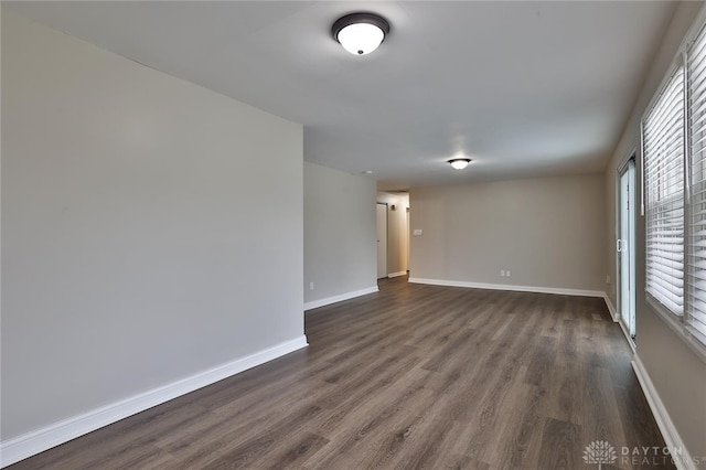 unfurnished room featuring dark hardwood / wood-style flooring