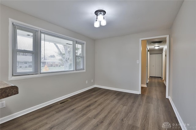 unfurnished room featuring dark hardwood / wood-style floors