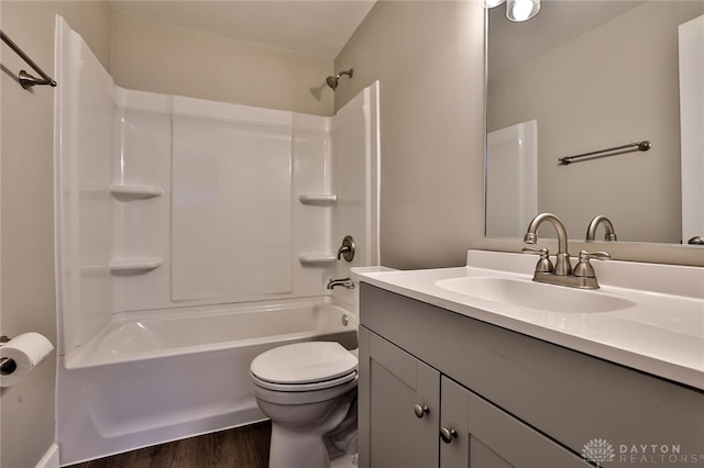 full bathroom with vanity, toilet, shower / bath combination, and wood-type flooring