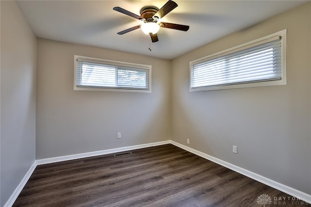 empty room featuring dark hardwood / wood-style floors and ceiling fan