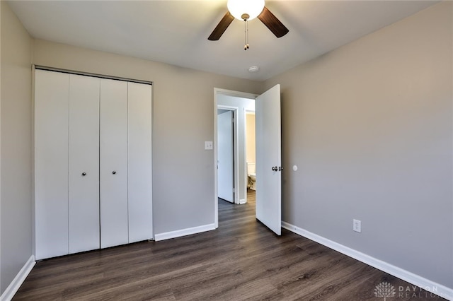 unfurnished bedroom featuring dark wood-type flooring, ceiling fan, and a closet