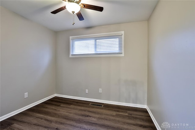 spare room featuring dark wood-type flooring and ceiling fan