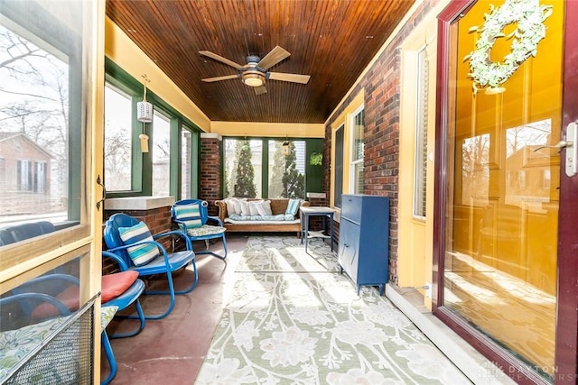 sunroom featuring wooden ceiling and ceiling fan