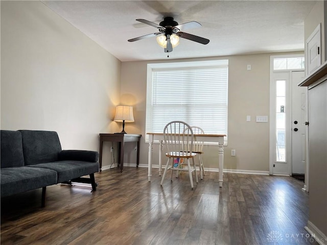 interior space with dark wood-type flooring and ceiling fan