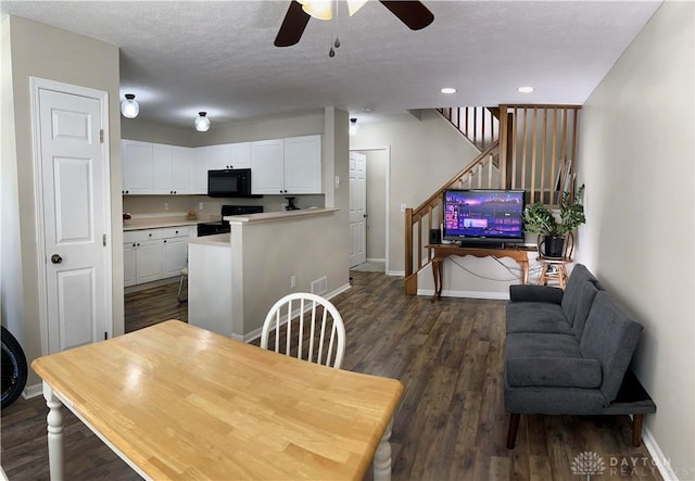 dining room featuring dark hardwood / wood-style flooring, ceiling fan, and a textured ceiling