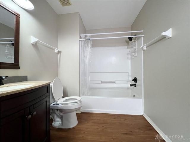 full bathroom with vanity, hardwood / wood-style floors, shower / bath combo, and toilet