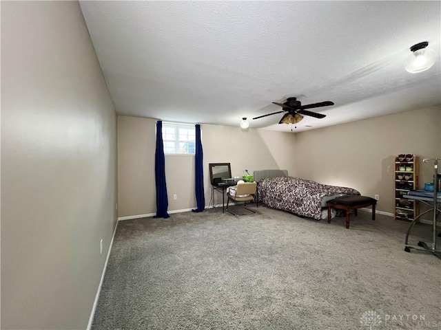 carpeted bedroom with ceiling fan and a textured ceiling