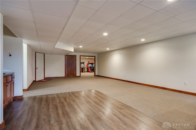 interior space with carpet and a paneled ceiling