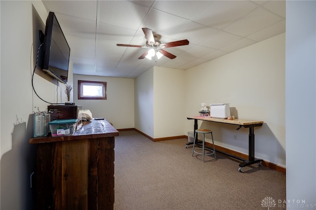 carpeted office space featuring ceiling fan