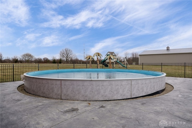 view of swimming pool featuring a playground