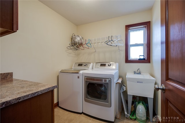 laundry room featuring washer and dryer and light tile patterned floors