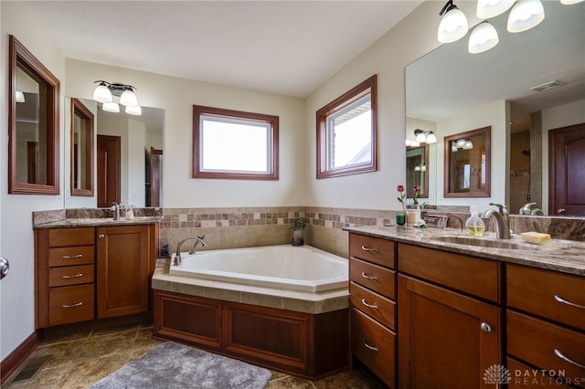 bathroom with vanity and a tub to relax in