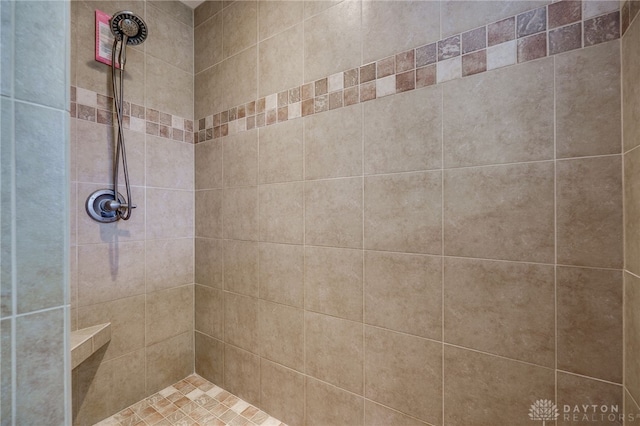 bathroom with a tile shower