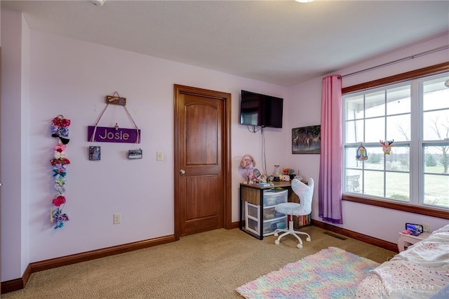 carpeted bedroom featuring multiple windows