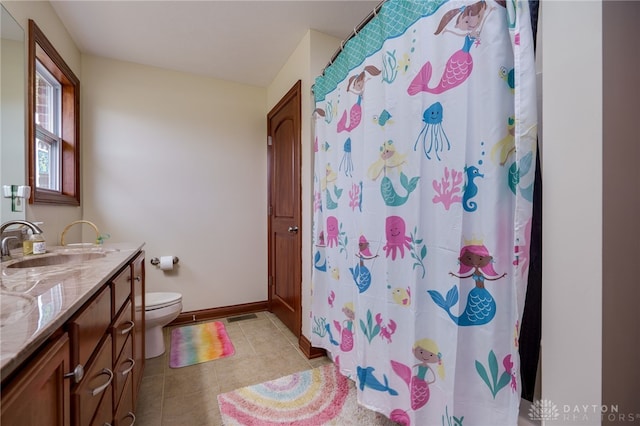 bathroom featuring walk in shower, tile patterned floors, vanity, and toilet