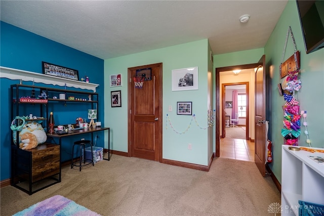 bedroom featuring light colored carpet and a textured ceiling