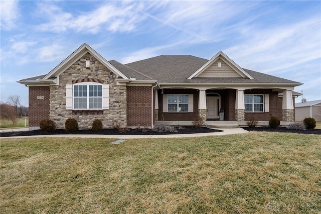 craftsman-style house featuring a porch and a front yard