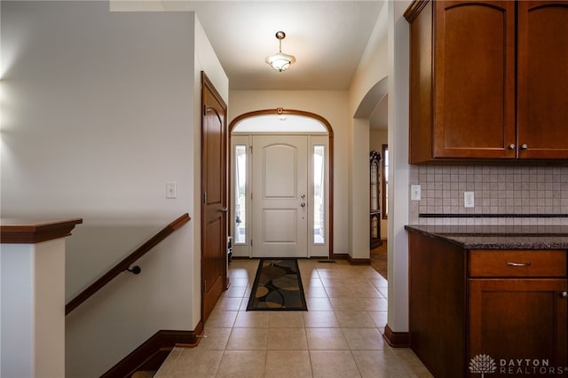 foyer entrance with light tile patterned floors